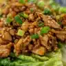 Hot Honey Chicken Lettuce Wraps served on a plate with fresh ingredients