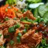 Delicious Korean Barbecue Chicken Salad topped with fresh vegetables and sesame dressing.