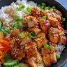 Korean BBQ chicken bowls topped with vegetables and served in a bowl