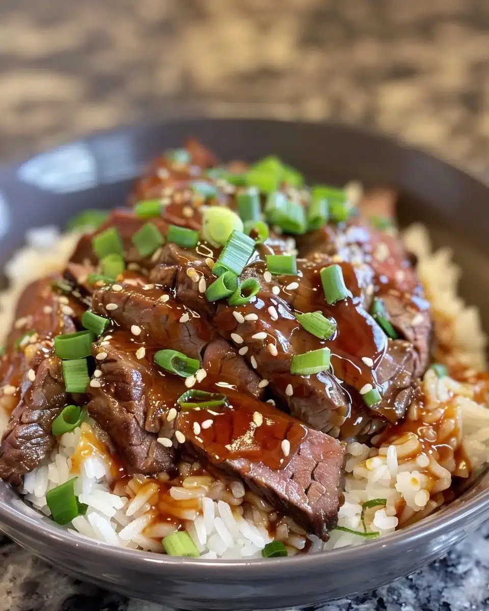 Korean BBQ Steak rice bowl with spicy cream sauce garnished with vegetables.