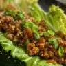 Lettuce-Wrapped Chicken served on a plate with fresh vegetables.