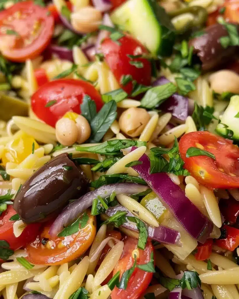Mediterranean-style orzo salad with fresh vegetables and dressing