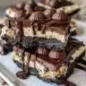 Mini peanut butter cup cheesecakes topped with chocolate and peanut butter.
