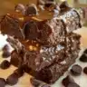 Decadent no-bake brownies ready to enjoy, topped with chocolate and nuts.