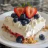 Delicious no-bake flag cheesecake bars topped with fresh berries.