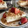 No-bake patriotic cheesecake bars topped with red, white, and blue berries