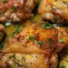 Oven-baked chicken thighs drizzled with balsamic glaze on a serving plate