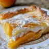 Delicious Peaches & Cream Bars topped with fresh peach slices.