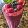 Protein-packed mixed berry Greek yogurt smoothie in a glass with fresh berries