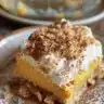 Delicious Pumpkin Magic Bars topped with pumpkin spice and creamy filling