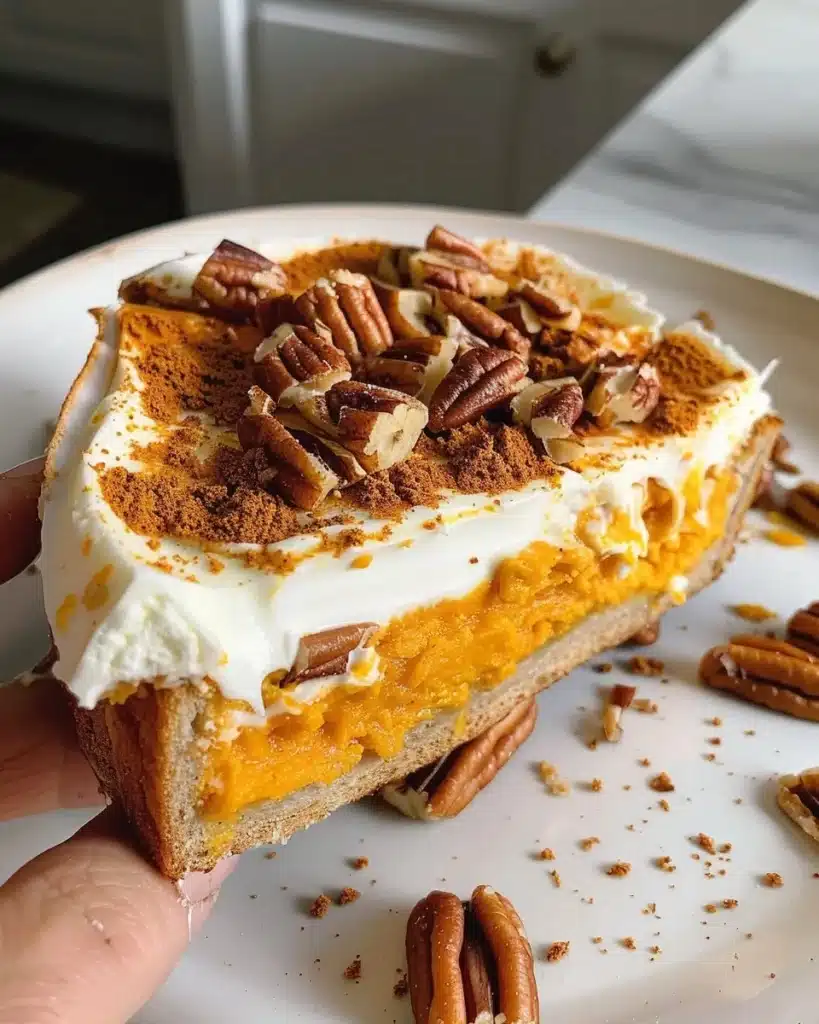 Pumpkin Stuffed French Toast topped with a crunchy pecan crust on a plate