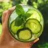 Glass of refreshing cucumber-mint lemonade with fresh ingredients