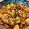 A bowl of robust chicken and vegetable stew with fresh ingredients