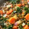 Bowl of robust lentil and kale soup garnished with herbs and spices