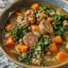 Delicious bowl of sausage lentil soup with fresh herbs and spices