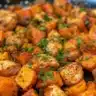 Skillet chicken dish with sweet potatoes, garnished and ready to serve.