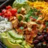 Delicious slow cooker chicken burrito bowl with rice, beans, and toppings