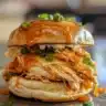 Spicy Buffalo chicken sliders served on a platter with dipping sauce