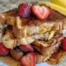 Strawberry Nutella French Toast Roll Ups with fresh fruit and creamy chocolate spread