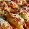 Plate of stuffed shells filled with ricotta cheese and topped with marinara sauce