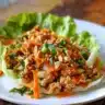 Thai Chicken Lettuce Wraps served with fresh herbs and dipping sauce
