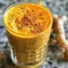 Turmeric Golden Milk Latte in a cup with spices and ingredients