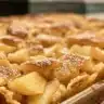 Delicious warm spiced apple pancakes topped with cinnamon and syrup.
