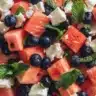Colorful watermelon salad with blueberries and feta cheese served in a bowl