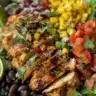 Zesty Southwest Chicken Salad Bowl topped with fresh veggies and grilled chicken