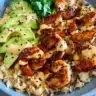 Teriyaki-glazed shrimp rice bowls with fresh vegetables and sesame seeds
