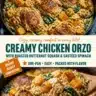 Creamy chicken orzo with roasted butternut squash and sautéed spinach in a bowl